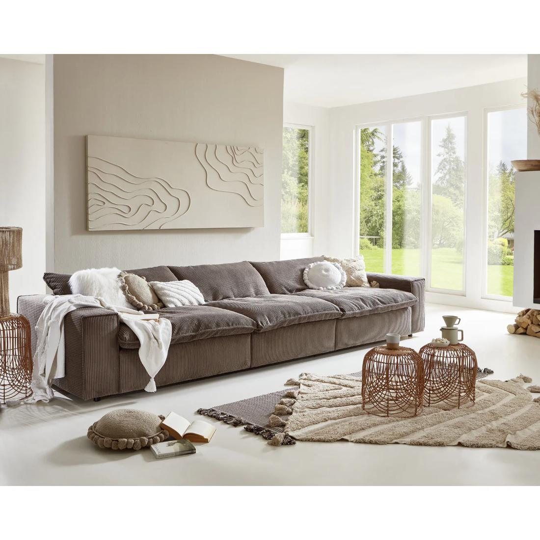 Modern Scandinavian style living room with a low profile taupe corduroy sectional sofa, textured neutral decor, and floor to ceiling windows in a Denver home by Baltic Design Furniture
