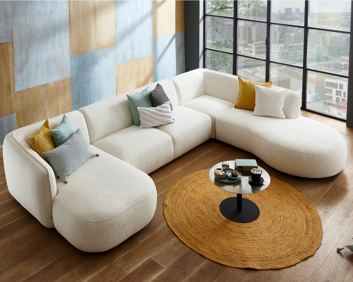 Cozy Scandinavian-style living space featuring Baltic Design Furniture sofa Loures U-Shape white boucle fabric