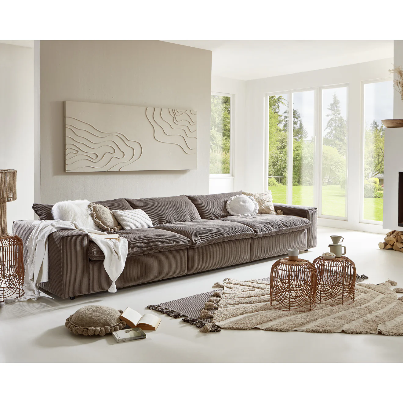 Modern Scandinavian style living room with a low profile taupe corduroy sectional sofa, textured neutral decor, and floor to ceiling windows in a Denver home by Baltic Design Furniture