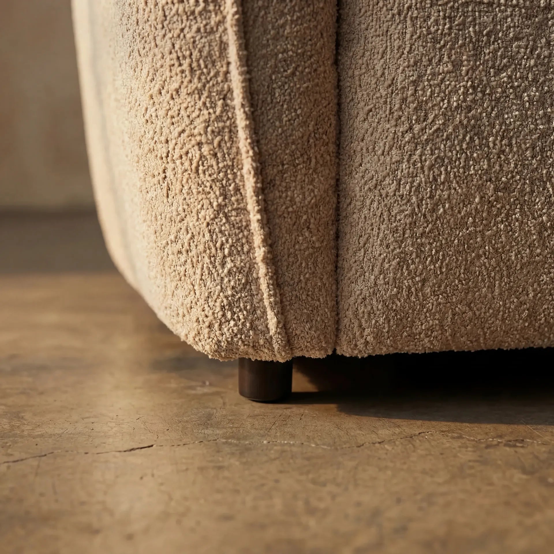 Loures Open-End Sectional — leg detail macro on concrete floor with boucle hem