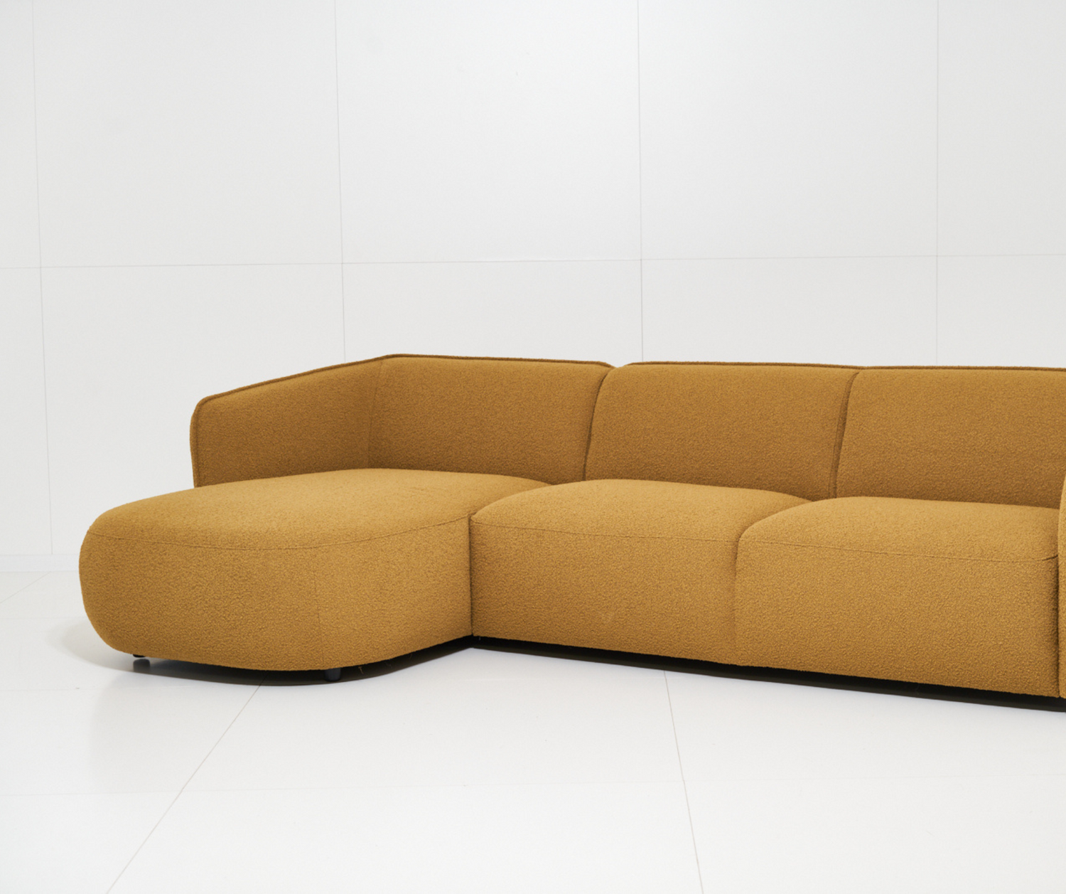 Mustard yellow sectional sofa on a white background