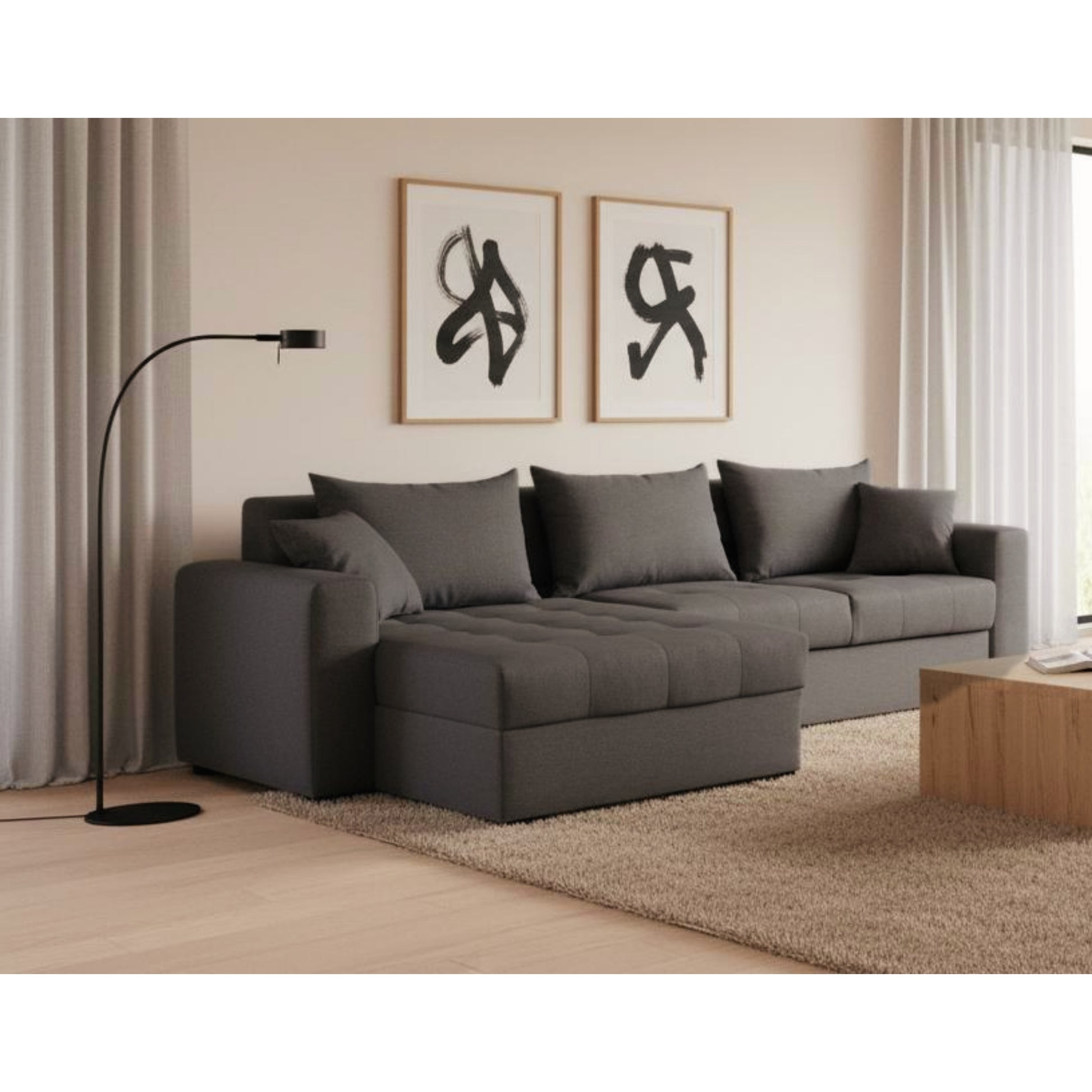 Gray sectional sofa in a living room with framed artwork on the wall.