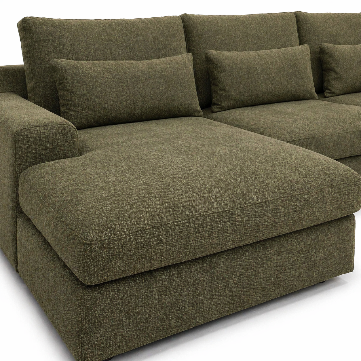 green sectional sofa with cushions on a white background